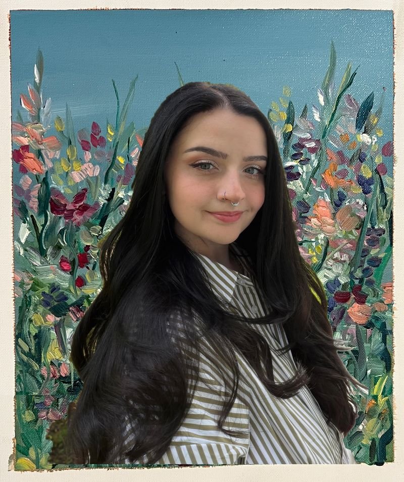 Liz Nicole in front of a painted field of flowers